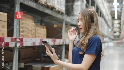 Asian female using tablet checking amount of stock product inventory on shelf at distribution warehouse factory. logistic business shipping and delivery logistic service. photo