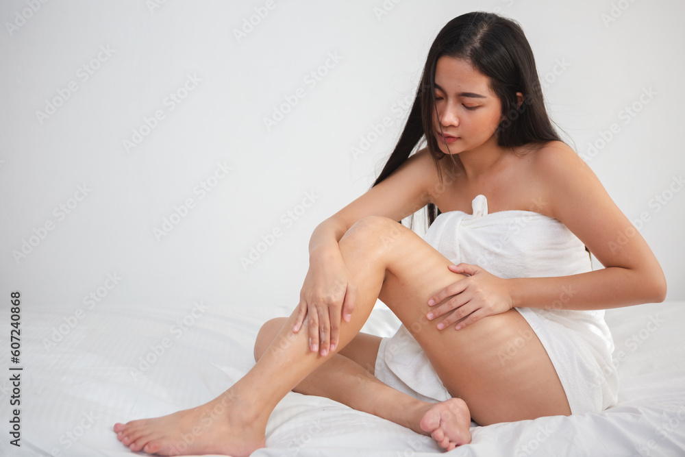 Body skincare treatment concept. woman applying skin cream leg area sittin in dressing room. Body care pampering, beauty routine. Body skincare treatment concept. woman applying skin cream leg area sittin in dressing room. Body care pampering, beauty routine.
