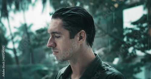 Concept of man lost hope suffering from depression stands in the rain and is sad. Sad man millennial suffers from depression, gets wet in heavy rain outdoor. Bad thoughts, mental health concept.