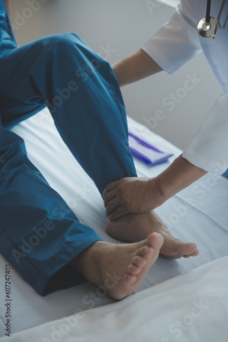 Doctor or Physiotherapist working examining treating injured arm of athlete male patient, stretching and exercise, Doing the Rehabilitation therapy pain in clinic.