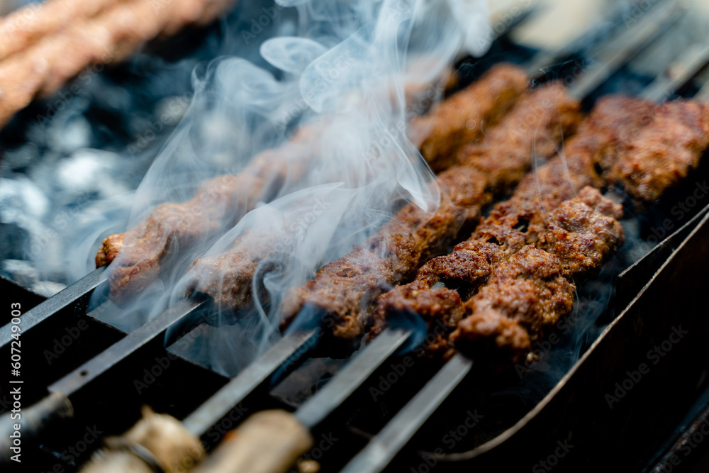 Sheekh Kabab being cooked over a grill. Sheekh Kabab being cooked over a grill.