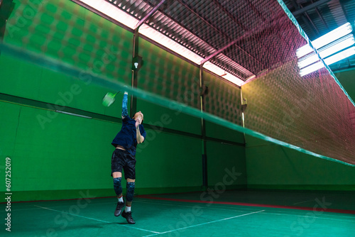 Asian badminton player in action on court © Kajornsiri