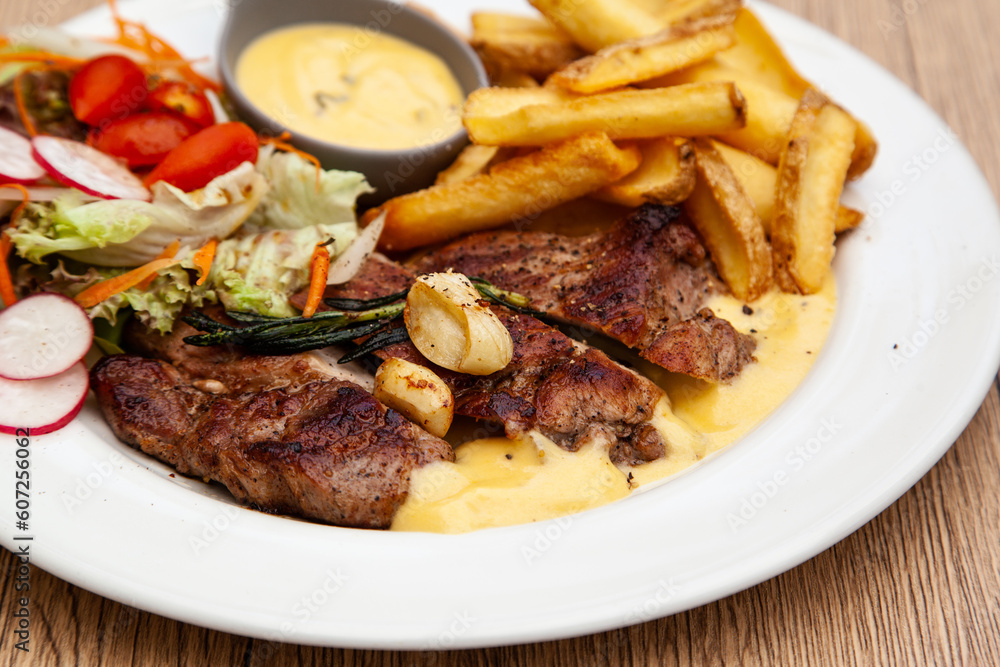 Pork steak with french fries and salad Pork steak with french fries and salad
