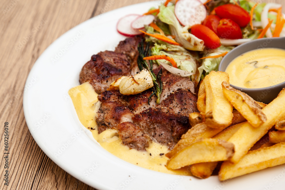 Pork steak with french fries and salad Pork steak with french fries and salad