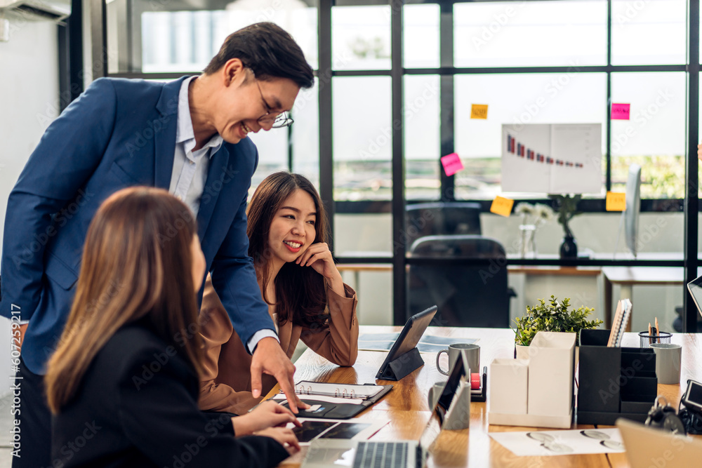 Group of asian business meeting and discussing strategy startup project analysis finance process.Success asian business people work plan and brainstorm marketing idea with laptop in office.Teamwork