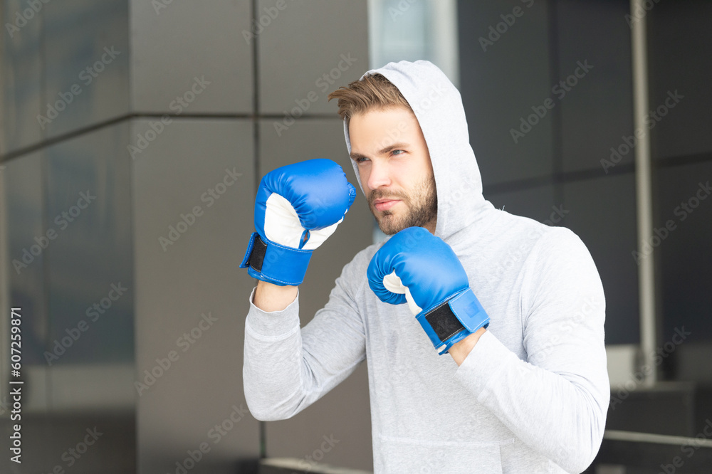 man boxing. man boxing in hoodie and gloves. man boxing outdoor. photo of man boxing and punching man boxing. man boxing in hoodie and gloves. man boxing outdoor. photo of man boxing and punching