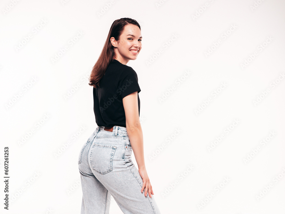 Young beautiful woman. Trendy carefree model in casual summer black T-shirt and blue jeans. Positive female isolated on white in studio. Cheerful and happy. Copy space, mockup Young beautiful woman. Trendy carefree model in casual summer black T-shirt and blue jeans. Positive female isolated on white in studio. Cheerful and happy. Copy space, mockup