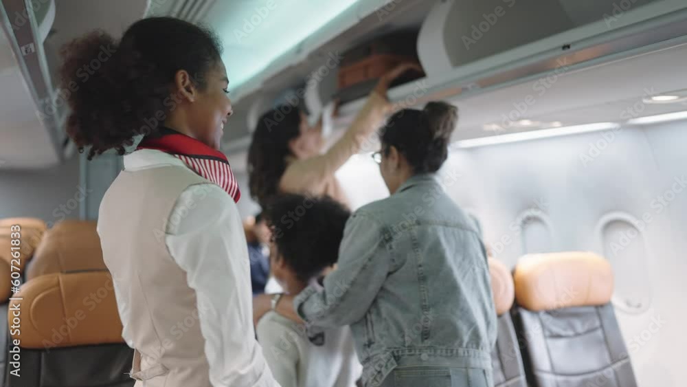 Women stewardess greeting passengers on airplane and checking passenger's boarding pass welcoming to the flight. Airline transportation