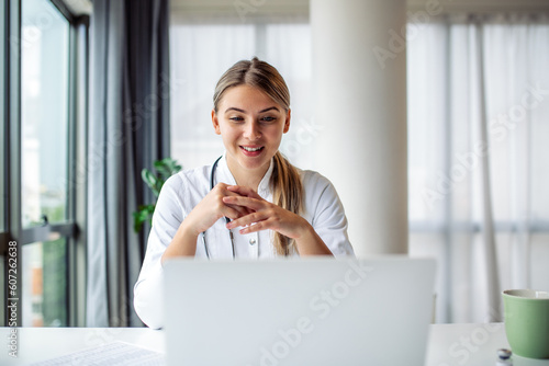 Female doctor having online therapy with her patient's, giving them advice while using telemedicine as a new normal during COVID-19 pandemic outbreak photo