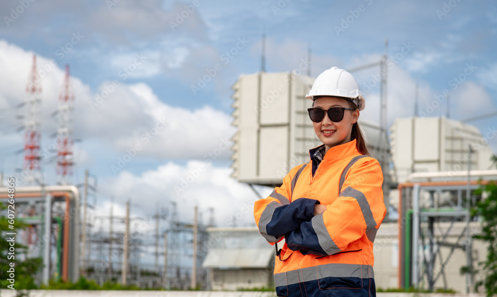 Engineer wearing uniform ,helmet and glass stand hand holding tablet computer,radio communication inspection and surveying work site progress with oil refinery power industrial factory background Engineer wearing uniform ,helmet and glass stand hand holding tablet computer,radio communication inspection and surveying work site progress with oil refinery power industrial factory background