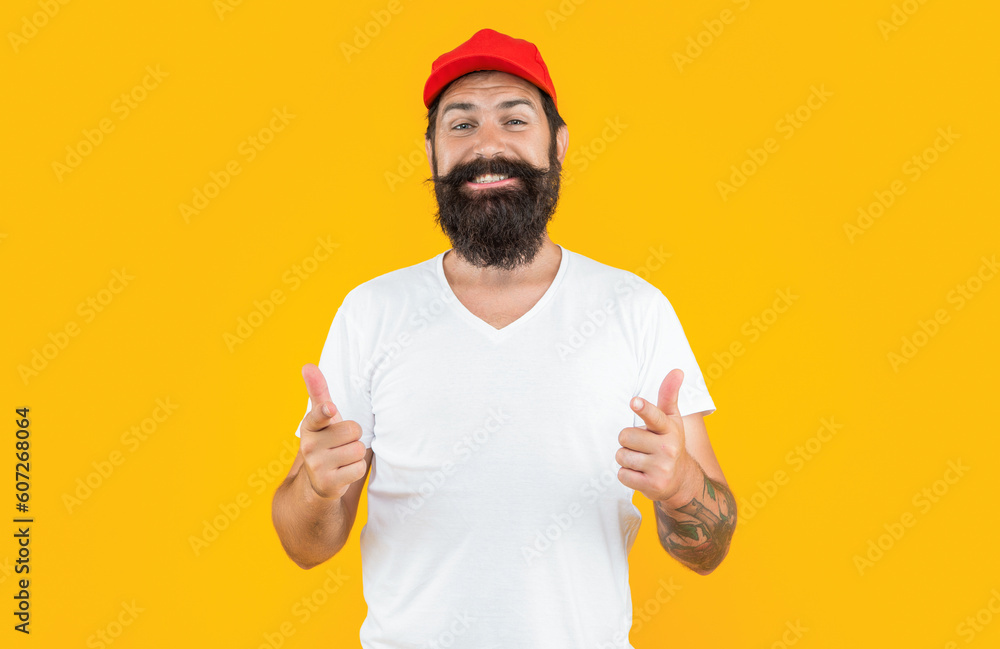 bearded deliveryman in studio, pointing finger. bearded deliveryman on background. bearded deliveryman in studio, pointing finger. bearded deliveryman on background.