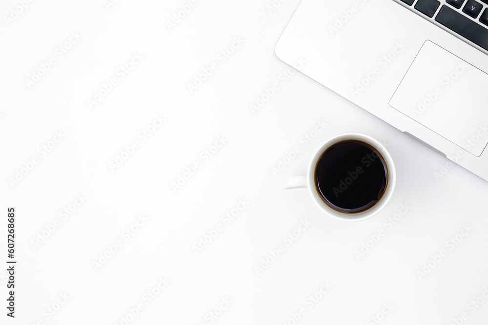 Laptop and a cup of black coffee on a white background, top view. Laptop and a cup of black coffee on a white background, top view.