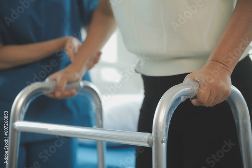 happy senior asian woman talking to physical therapist in rehab center