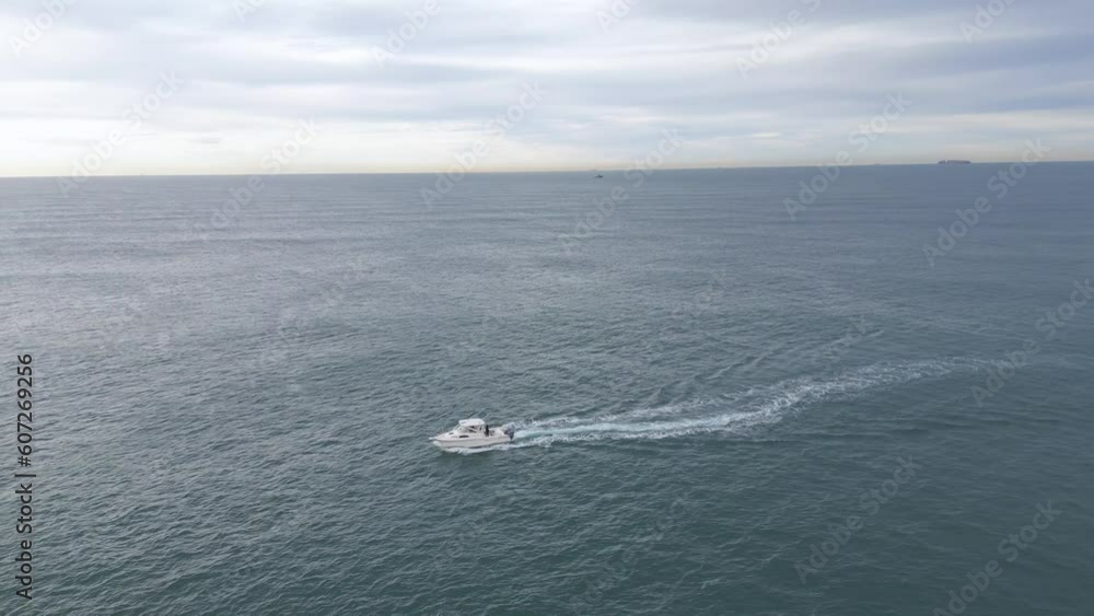 Small fishing boat in the open ocean on sunrise
