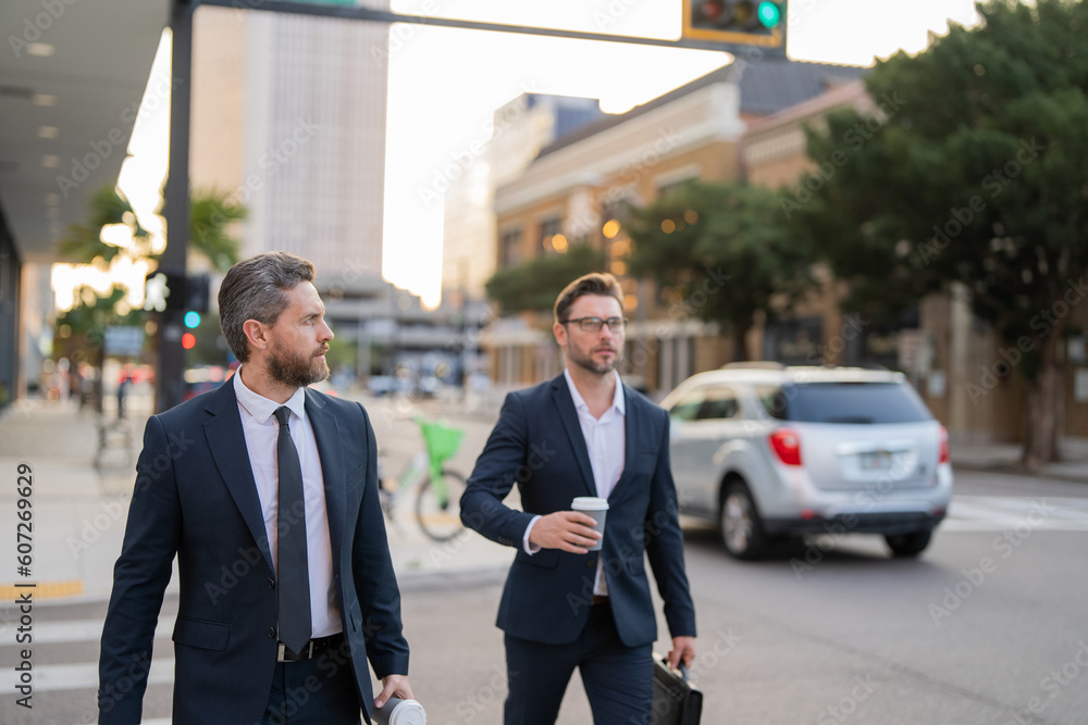selective focus of businessmen walk in the street. businessmen walk outdoor.