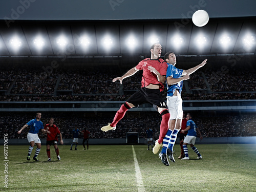 Soccer players jumping for ball on field © KOTO