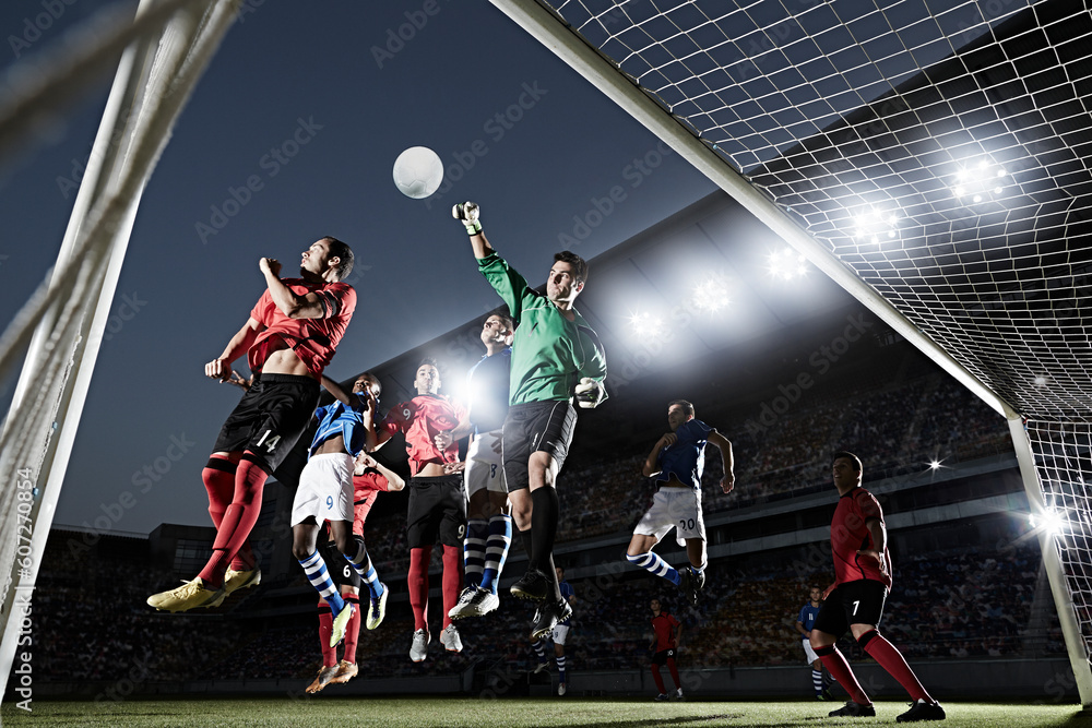 Soccer players defending goal