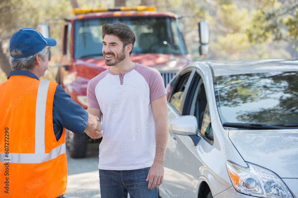 Man shaking hands with roadside mechanic Man shaking hands with roadside mechanic