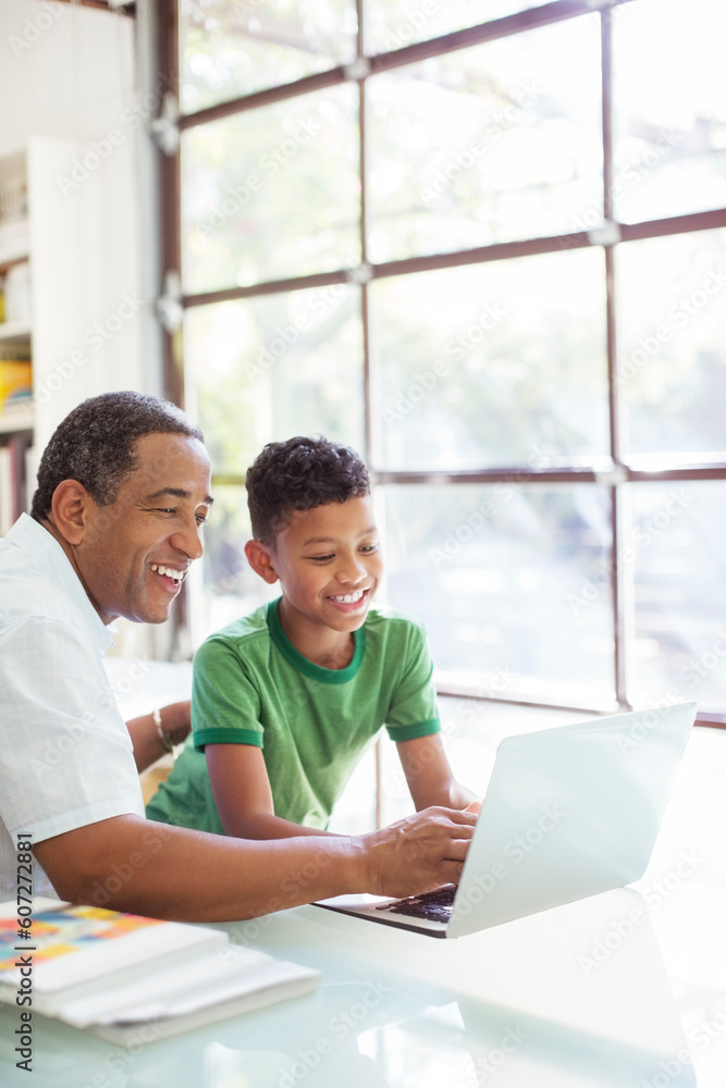 Grandfather and grandson using laptop Grandfather and grandson using laptop