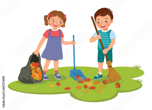 Happy little kids boy and girl raking fallen autumn leaves into plastic bag cleaning up in the garden together