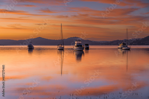 Beautiful sunrise waterscape with high cloud  reflections and boats