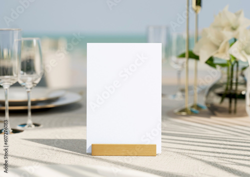 Mockup white blank space card, for greeting, table number, wedding invitation template on wedding table setting background. with clipping path. 3D rendering