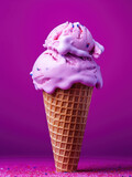 Pink ice cream with pink icing in a waffle cone on a purple background