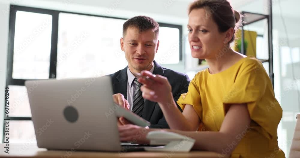 Two hired managers are discussing a business project talking in office, using tablet computer. Woman boss manager training new employee and trainee Two hired managers are discussing a business project talking in office, using tablet computer. Woman boss manager training new employee and trainee
