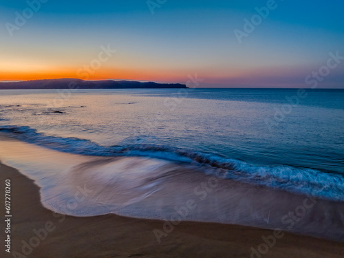 Aerial sunrise over the calm sea and smoke haze clear sky