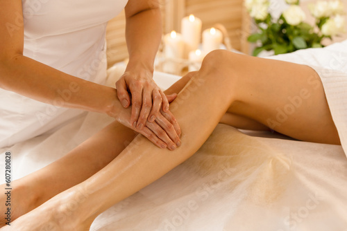  Woman getting legs lymphatic drainage massage in spa salon 2