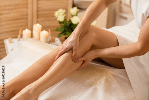  Woman getting legs lymphatic drainage massage in spa salon 1