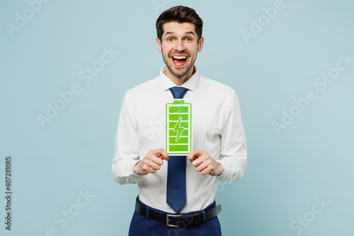 Young employee business man corporate lawyer wears classic formal shirt tie work in office hold in hand green battary charge card sign isolated on plain pastel light blue background studio portrait. photo