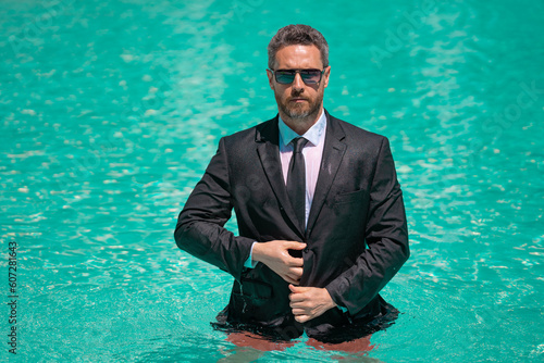 photo of businessman boss relax in summer pool with copy space. businessman boss in summer pool