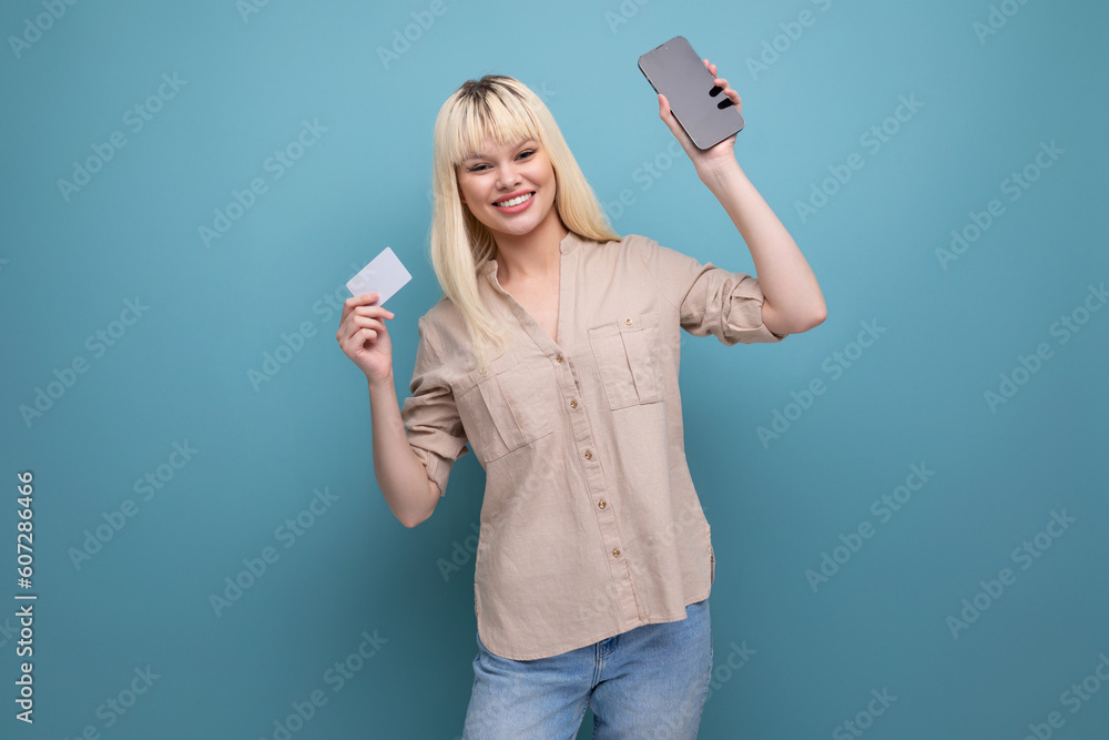 blonde european young woman with credit card and smartphone blonde european young woman with credit card and smartphone