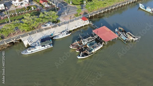 fly over bridge crosses even the river, Aerial view of fishing boats moored in the river in morning time at Chalermpragiad bridge Pattani,Thailand