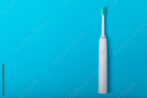 Sonic electric toothbrush on a blue background. Oral hygiene. Dental care. Dentistry concept. Place for text. Place to copy.