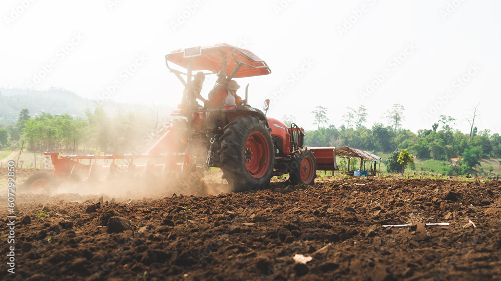 Fototapeta premium Farmer in tractor preparing land with seedbed cultivator as part of pre seeding activities in early spring season of agricultural works at farmlands Cultivated field Agronomy farming husbandry concept