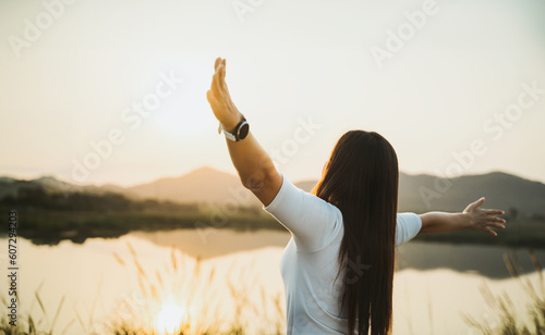 Happy woman spreading arms and watching the mountain. Travel Lifestyle success concept adventure active vacations outdoor freedom emotions.