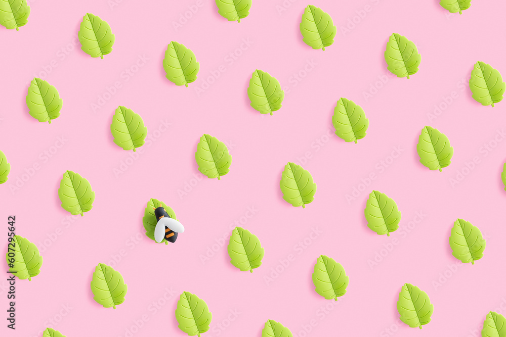 Toy miniature bee on th leaf. Summer pattern of toy green leaves on pink background. Toy miniature bee on th leaf. Summer pattern of toy green leaves on pink background.