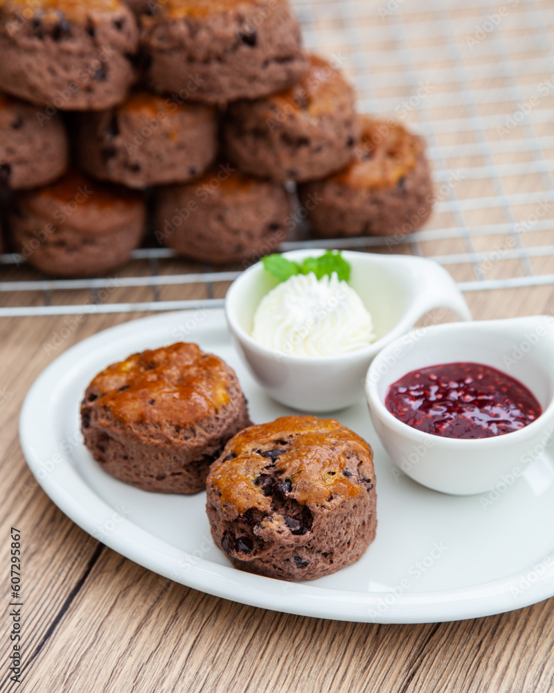 Chocolate scone with clotted cream and homemade raspberry jam Chocolate scone with clotted cream and homemade raspberry jam