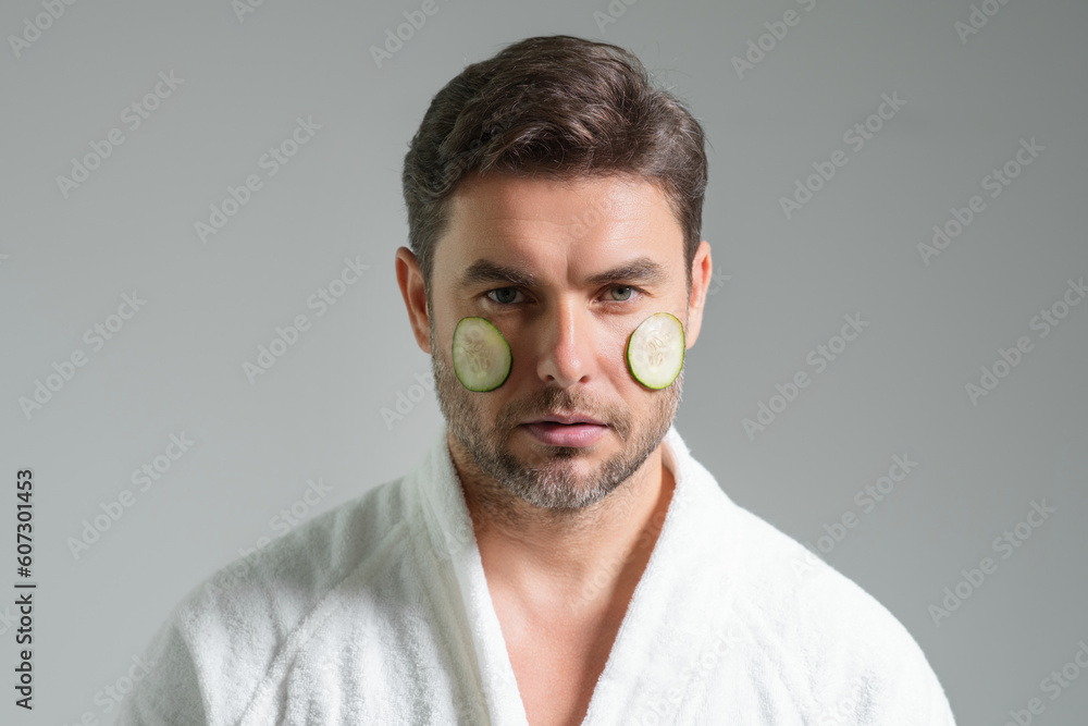 Beauty man with cucumber mask. Cucumber for cosmetics skin mask. Facial mask with cucumber. Spa, dermatology, wellness and facial treatment concept. Male cosmetic mask with cucumber. Beauty man with cucumber mask. Cucumber for cosmetics skin mask. Facial mask with cucumber. Spa, dermatology, wellness and facial treatment concept. Male cosmetic mask with cucumber.