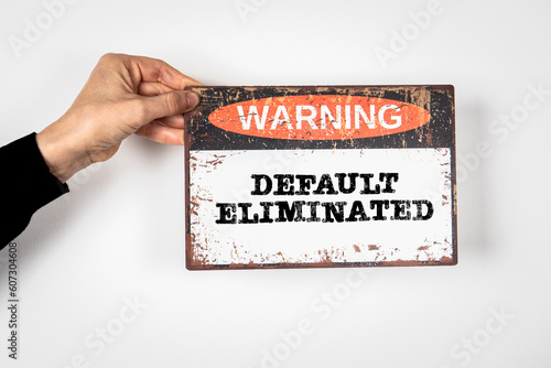 Default Eliminated. Warning sign with text on a white background