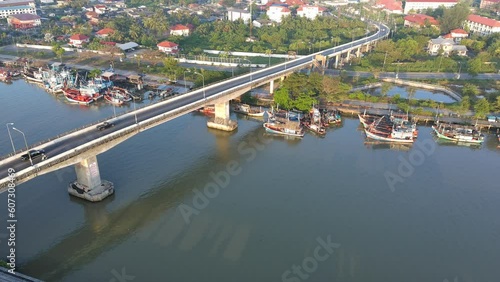 drone fly over bridge crosses even the river, Aerial view of cars driving on bridge in morning time at Chalermpragiad bridge Pattani,Thailand