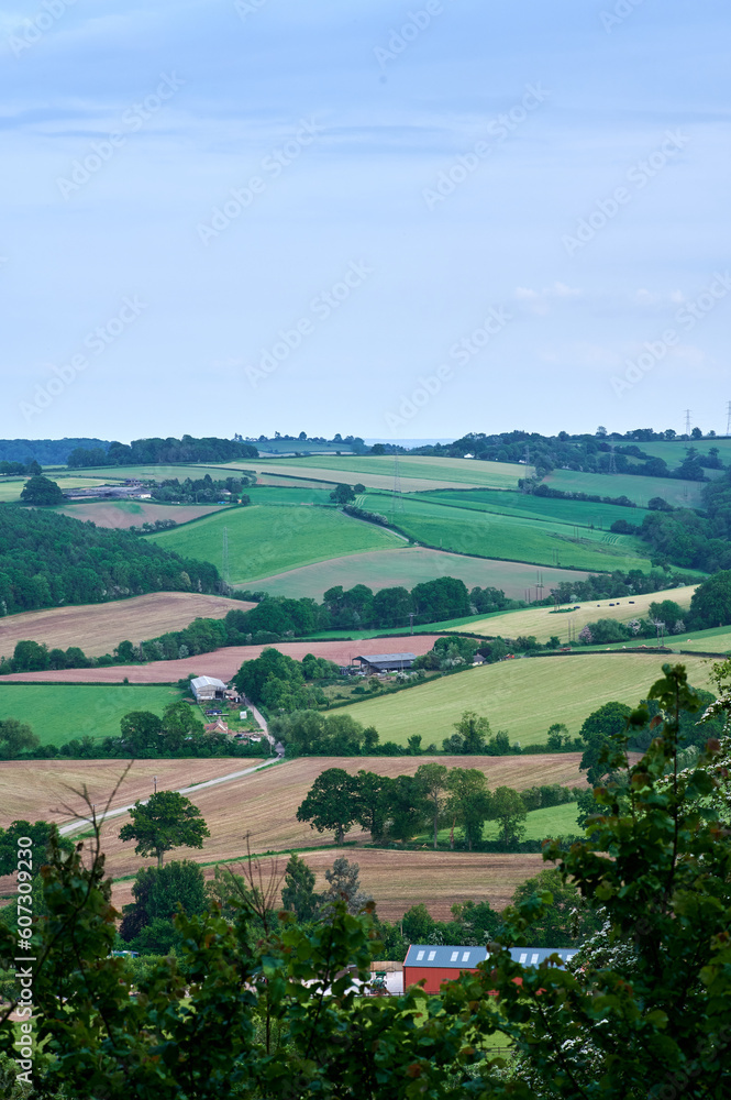 Portrait view over english rolling hills and farm fields in countryside
