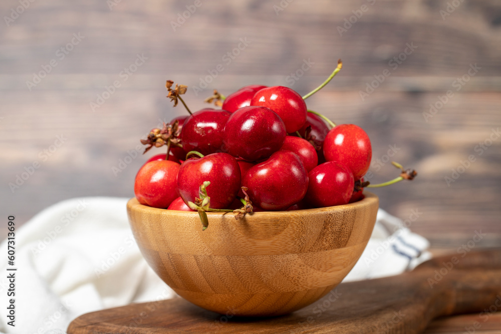 Cherry in bowl. Organic farm products. Fresh cherry on wooden background Cherry in bowl. Organic farm products. Fresh cherry on wooden background