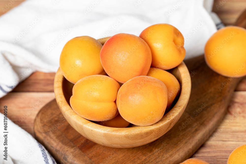 Apricot in bowl. Organic farm products. Fresh apricots on wooden background. Close up Apricot in bowl. Organic farm products. Fresh apricots on wooden background. Close up