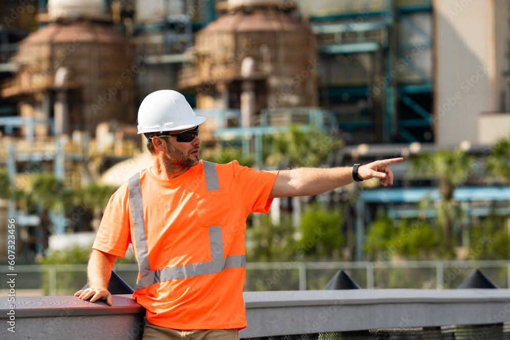 Professional heavy industry engineer worker man in safety uniform and hard hat helmet. Factory engineer. Manufacturing facility working. Heavy industry manufacturing factory worker. Professional heavy industry engineer worker man in safety uniform and hard hat helmet. Factory engineer. Manufacturing facility working. Heavy industry manufacturing factory worker.