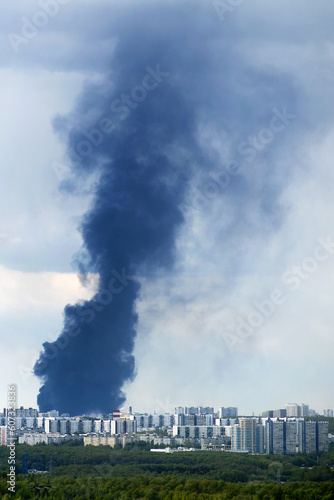 A fire in Russia city produced thick black smoke that covered Moscow s residential buildings  creating a somber scene against the backdrop of the sky and houses.