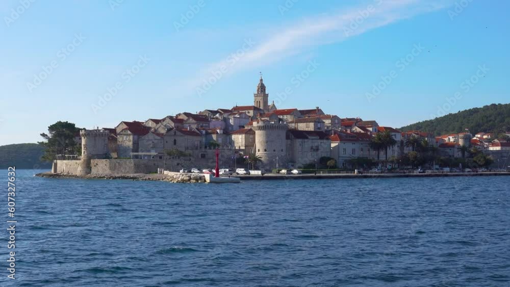Panorama of historic town of Korcula shoot from a cruising boat. View of stone walls, towers, churchs and old houses. Panorama of historic town of Korcula shoot from a cruising boat. View of stone walls, towers, churchs and old houses.