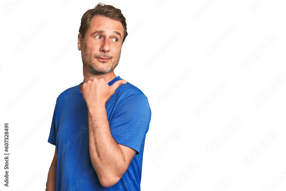 Fototapeta premium A middle-aged man isolated points with thumb finger away, laughing and carefree.